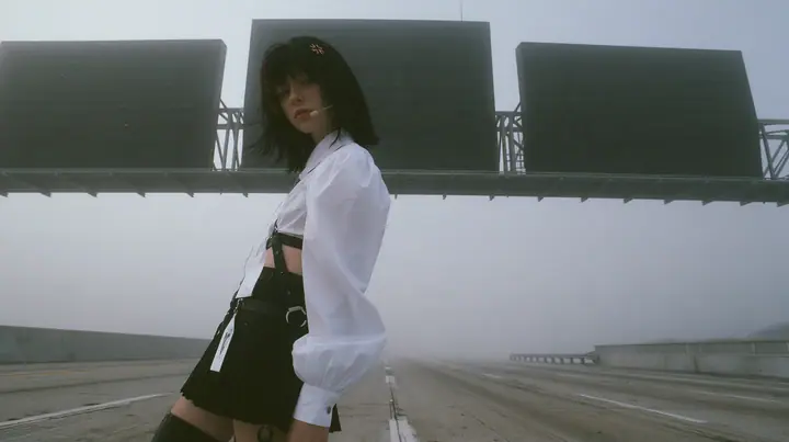 three enormous split-flap signs on steel gantries spanning an empty freeway in white fog, blank black flaps, a young Caucasian American woman with pale skin and light freckles, a glossy black blunt jaw-length bob…